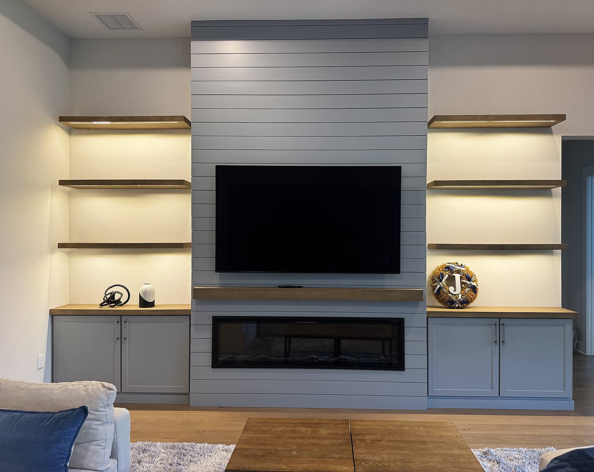 Custom built-in entertainment center with a fireplace and cabinetry in Silverleaf, St. Augustine, Florida