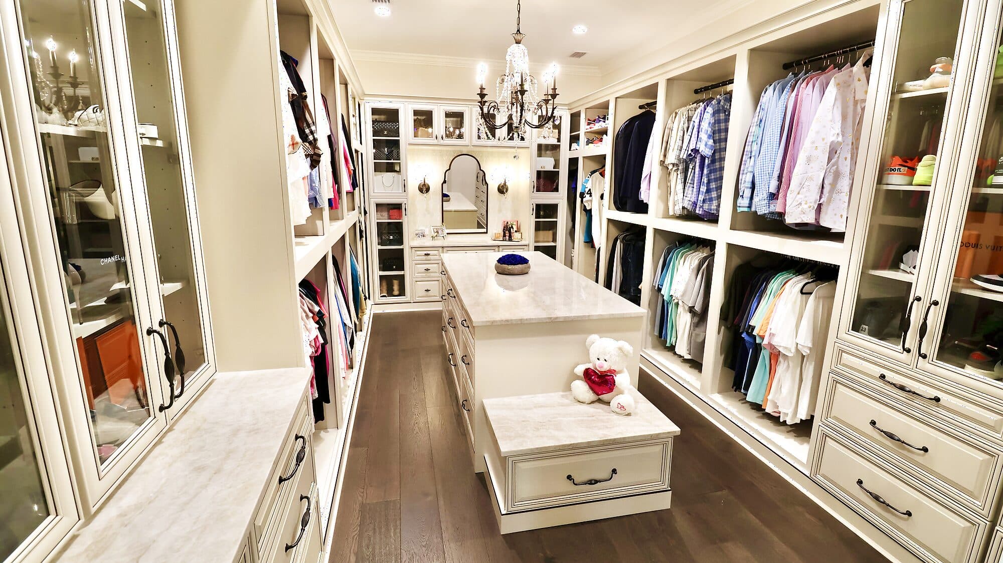 Custom dressing closet with a center island and floor-to-ceiling cabinetry in a custom home in Nocatee, Florida
